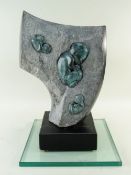 GLENN MORRIS bronze and carved springstone - 'Fossils' on ebonised plinth and plate glass base,