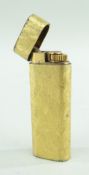 CARTIER GOLD PLATED CIGARETTE LIGHTER. oval section with textured finish, 7cms high Comments:
