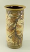 A GWILI STONEWARE POTTERY VASE of ribbed cylindrical form with flared rim, decorated with a branch