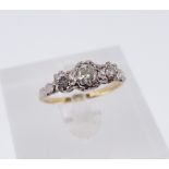 18CT GOLD & PLATINUM THREE-STONE DIAMOND RING, the illusion set diamonds totalling 0.4cts overall