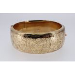 9CT GOLD BANGLE, scroll engraved, 33.0gms