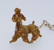 18CT GOLD POODLE BROOCH of textured design with ruby eyes, 12.2gms, in 'Westgate Jewellers' box