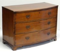 REGENCY MAHOGANY BOW FRONT CHEST, reeded top above three graduated long drawers with ebony
