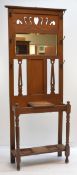 EDWARDIAN ARTS & CRAFTS-STYLE OAK HALL STAND, pierced frieze above beveled mirror, uprights fitted