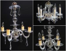 PAIR OF MOULDED GLASS FOUR BRANCH CEILING LIGHTS hung with shaped bevelled drops, 60cms high x 52cms