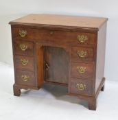 GEORGE II-STYLE WALNUT KNEEHOLE DESK, moulded top above an arrangement of seven drawers around