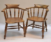TWO ELM CAPTAIN'S CHAIRS, bowed horseshoe rails and spindle sides, turned legs joined by H-