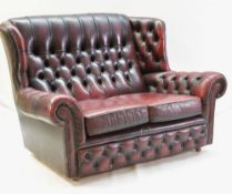 MAROON LEATHER BUTTON-BACK UPHOLSTERED WING-BACK SETTEE, with two loose cushions, 91h x 140w x