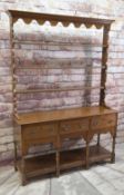 REPRODUCTION OAK SOUTH WALES DRESSER with open rack and a base fitted with drawers and potboard