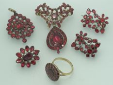 A SUITE OF 19TH CENTURY FOIL BACKED GARNET JEWELLERY including a circular set 9ct gold ring, size