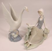 LLADRO FIGURINE - a seated girl with a dove, 17cms tall, also a Nao swan, 18.5cms tall