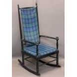 SPINDLE BACK EBONISED ROCKING ARMCHAIR CIRCA 1900 with tartan upholstered seat and loose back pad,