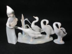 LLADRO - a group of three geese on an oval rusted base in various modes, a single standing