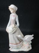LLADRO - young standing girl with goose alongside and gosling in her arms, 30cms H