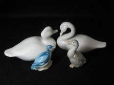 PLAIN WHITE POTTERY SEATED DUCKS, A PAIR and two others