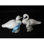 PLAIN WHITE POTTERY SEATED DUCKS, A PAIR and two others