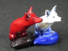 ROYAL DOULTON FLAMBE SEATED FOX and one other in white colourway, 10.5cm heights (the latter