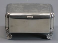 RUSSIAN SILVER OBLONG CIGARETTE BOX - on four corner shell type supports, the lid having geometric