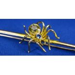 9CT GOLD BAR BROOCH - 7.5cms L, featuring a large spider with large circular citrine and small