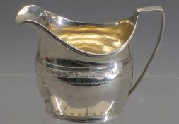 SILVER GEORGIAN CREAM JUG - with delicate leaf and other decoration and having a long ridged handle,