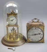 BRASS ANNIVERSARY CLOCK UNDER GLASS DOME and a brass mantel clock with openwork carry handle