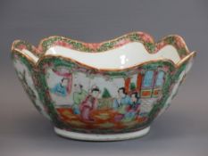 CIRCA 1900 CHINESE CANTON FAMILLE ROSE BOWL - 25cms diameter with lobed rim, the body with panels of