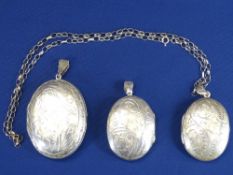 925 OVAL BRIGHT CUT LOCKET & CHAIN, 15.6grms, a further similar size and a large example, 34.6grms