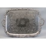 AN IMPRESSIVE LARGE ELECTROPLATED TWIN-HANDLED TRAY - having a floral and scrolled border with