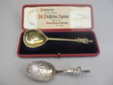 GILT SILVER CASED SPOON with card entitled 'Reproduction of the Celebrated St Nicholas spoon sold in