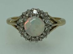 18CT GOLD OPAL & DIAMOND RING SIZE M - 4.2grms, the central opal surrounded by 10 diamonds in an