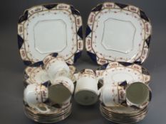 WARWICK CHINA PART TEASET in cobalt and gilt with floral detail, thirty two pieces