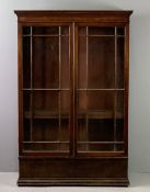 VINTAGE TWO DOOR GLAZED BOOKCASE on a plinth base, having interior adjustable shelving, 148cms H,