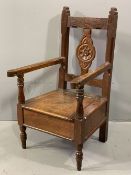 CARVED OAK CHILD'S ARMCHAIR COMMODE, the lift-up seat with interior potty aperture, peg-joined