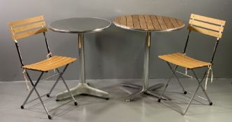 CAFE TYPE SET OF TWO CIRCULAR TOPPED TABLES and two folding chairs, 74cms H, 69cms D and 73cms H,