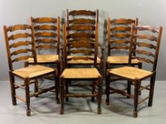 SET OF SIX (5 + 1) RUSH SEATED LADDERBACK DINING CHAIRS, 110cms H, 59cms W, 44cms D the seat (the