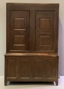 ANTIQUE OAK HANGING CUPBOARD of two upper twin panel doors and interior wooden hanging pegs, over