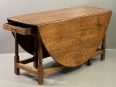 WAKE TYPE OAK TWIN FLAP GATE LEG TABLE having opposing end drawers, 76cms H, 152cms L, 57cms W (