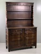 PRIORY STYLE OAK DRESSER, the shaped sided rack with two shelves and carved frieze detail, over a