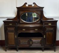 EDWARDIAN MAHOGANY MIRROR BACKED SIDEBOARD - having a bow front and carved detail, 169cms H,