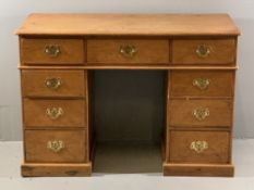 VINTAGE STRIPPED PINE KNEEHOLE DESK of three frieze drawers and twin banks of three drawers on