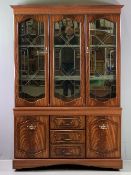 REPRODUCTION MAHOGANY DISPLAY SIDEBOARD having three doors with cut detail, glass top, mirrored