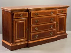 REPRODUCTION CROSSBANDED MAHOGANY BREAKFRONT SIDEBOARD having four central drawers with brass