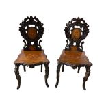 Pair of Black Forest carved musical hall chairs