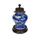 A blue and white Chinese Kangxi blue moon prunas vase (marked to base) on wooden stand.