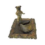 Cold painted bronze figure of a pug dog with bag on a rug, modelled as a desk set