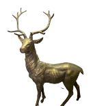 A painted cast metal sculpture of a standing stag on base