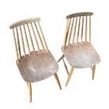 A pair of light Ercol stick back dining chairs