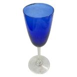An oversized blue and clear wine glass
