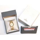 An early 21st century 18 carat gold and diamond set quartz, centre seconds, calendar wristwatch. Ome