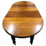 A Victorian walnut extending dining table